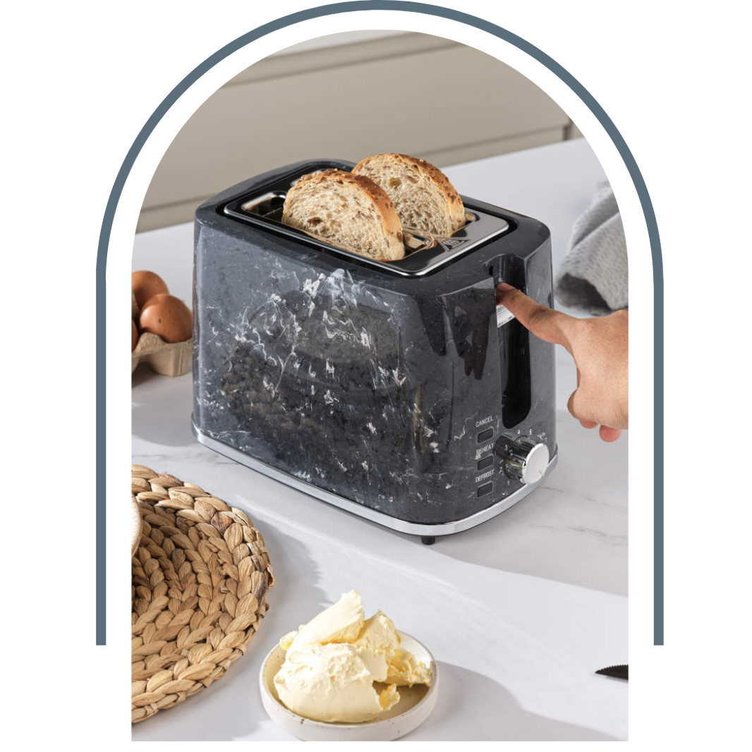 Person using a marble-patterned toaster with bread slices on a kitchen counter.